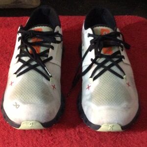White and Black Athletic Shoes with Orange Accents